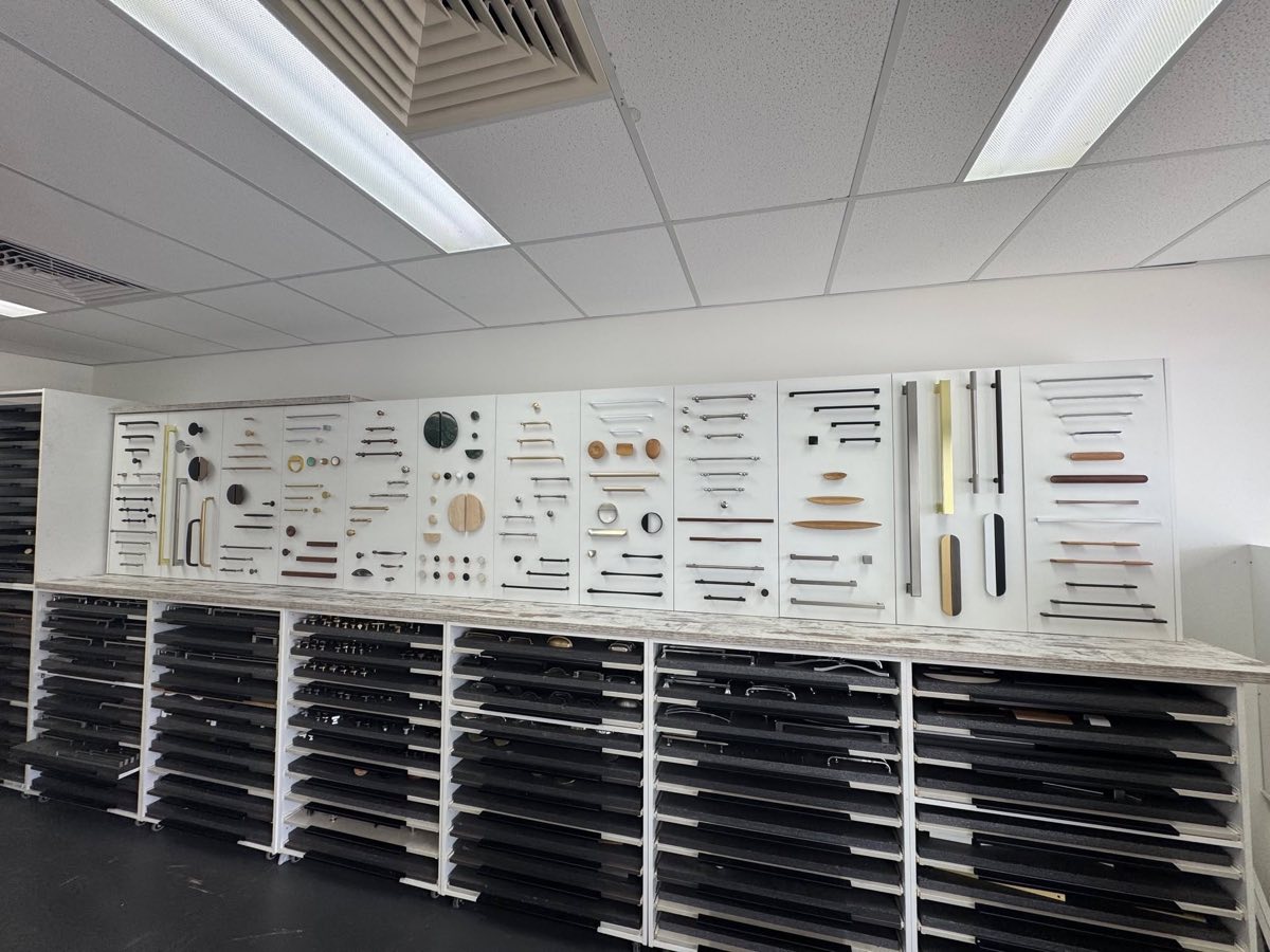 Cabinet handle showroom display wall with handles, knobs and pulls in brass, black, timber and chrome finishes at Bauer's Hardware Collections, Brisbane